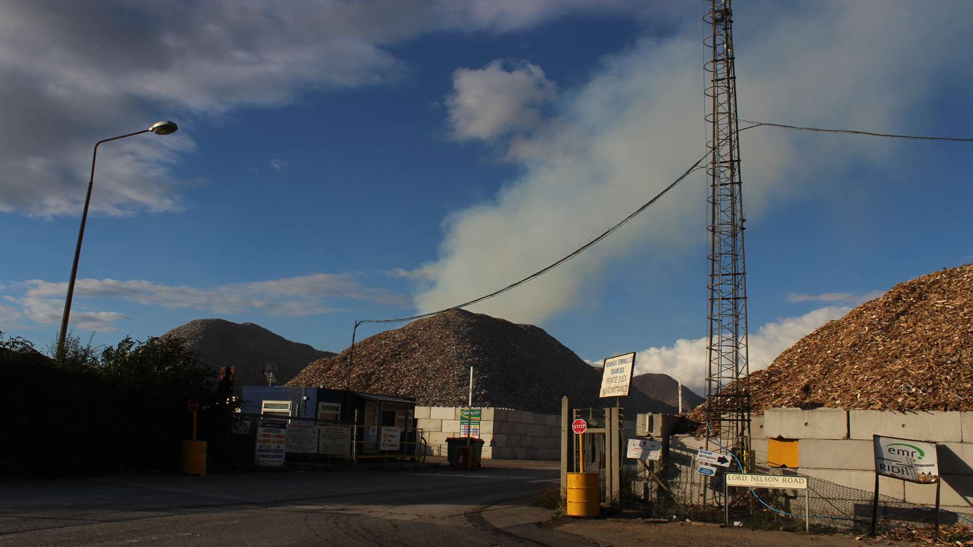 Smoke billowing from the mountain of wood chippings