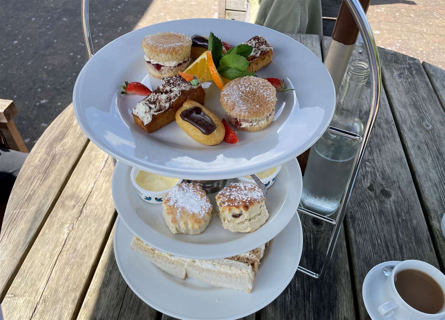 There is a selection of sandwiches, cakes and scones