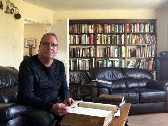 Ken Nickoll with a 17th century parish register for Elham