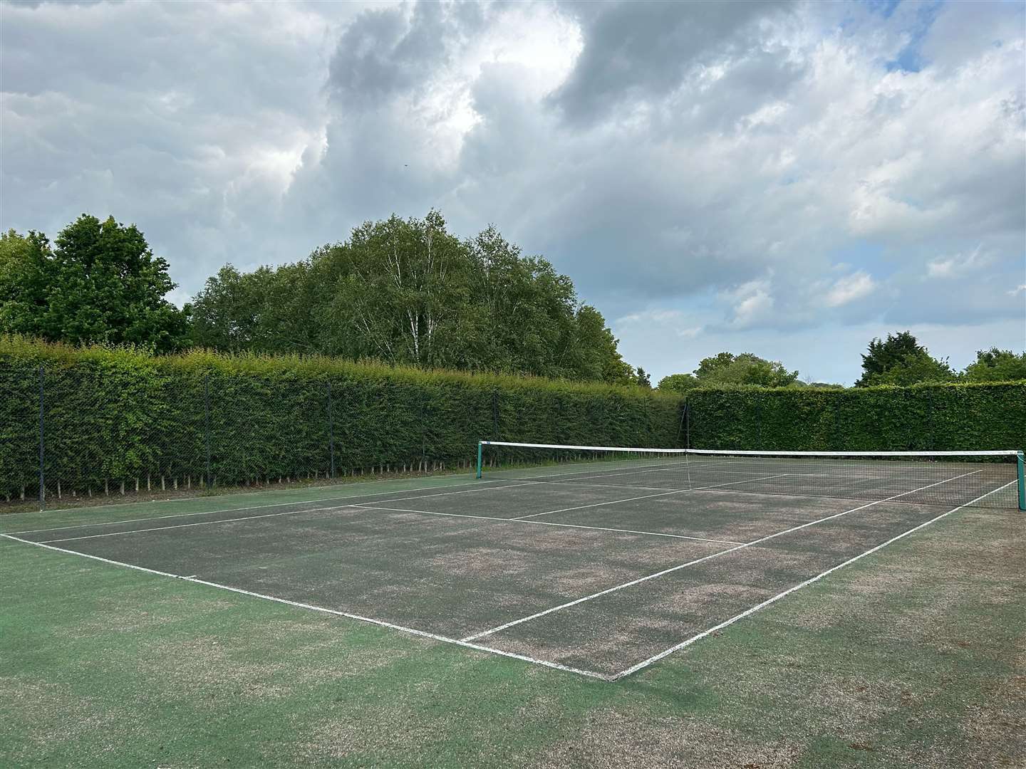 A tennis court features in the grounds