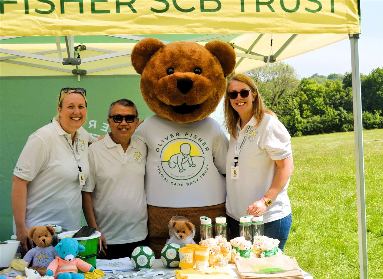 Dr Aung Soe mans stall at fun run with nurse Sam (left) and matron Sarah Clarke