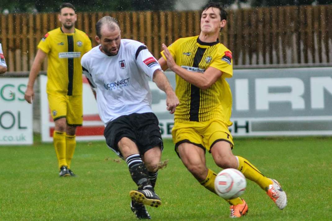 Herne Bay's Sam Hasler challenged by Faversham's Darren Marsden on Monday. Picture: Alan Langley