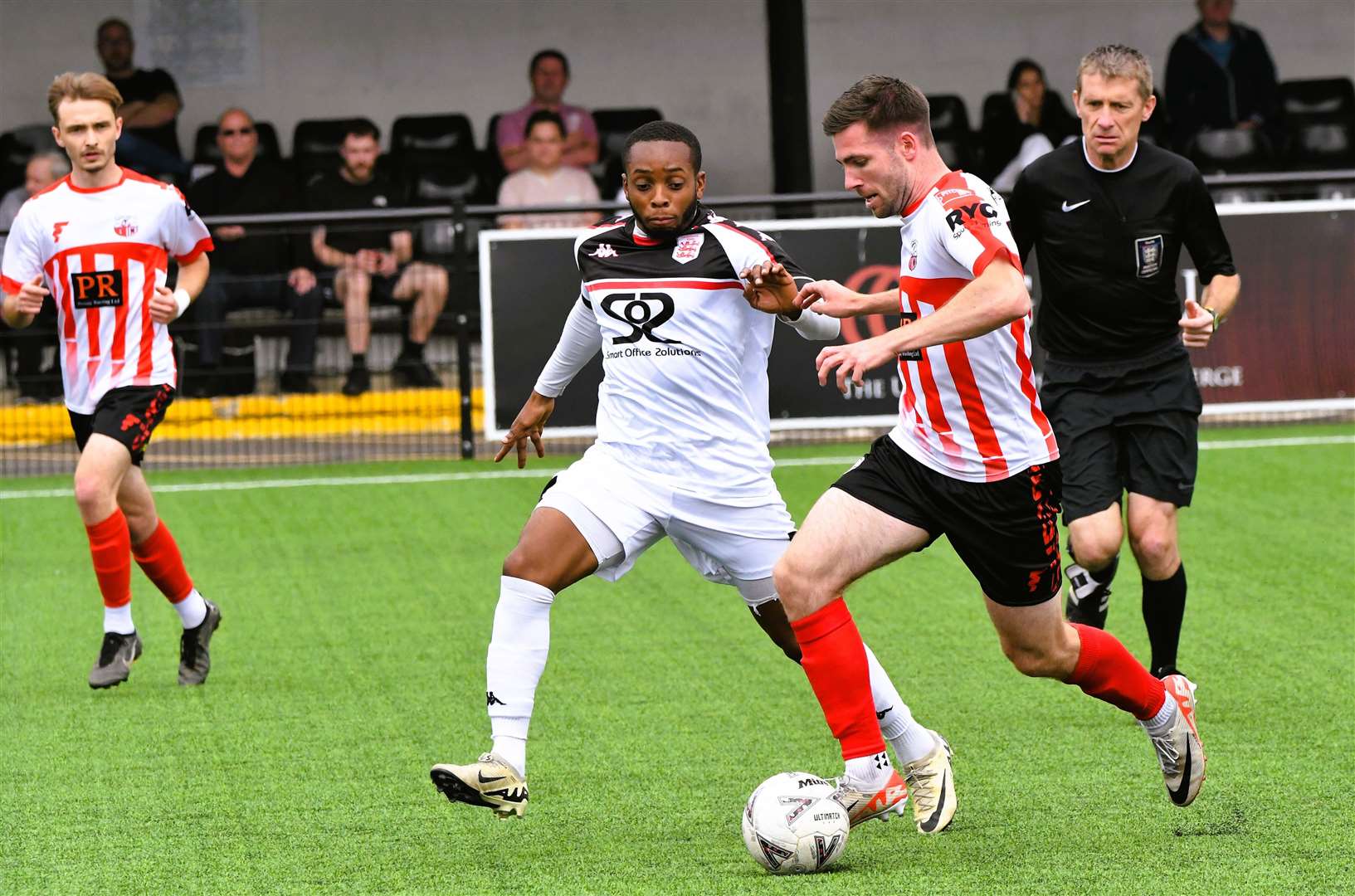 Sheppey winger Danny Leonard tries to get past Faversham's Kieron Campbell in pre-season Picture: Marc Richards