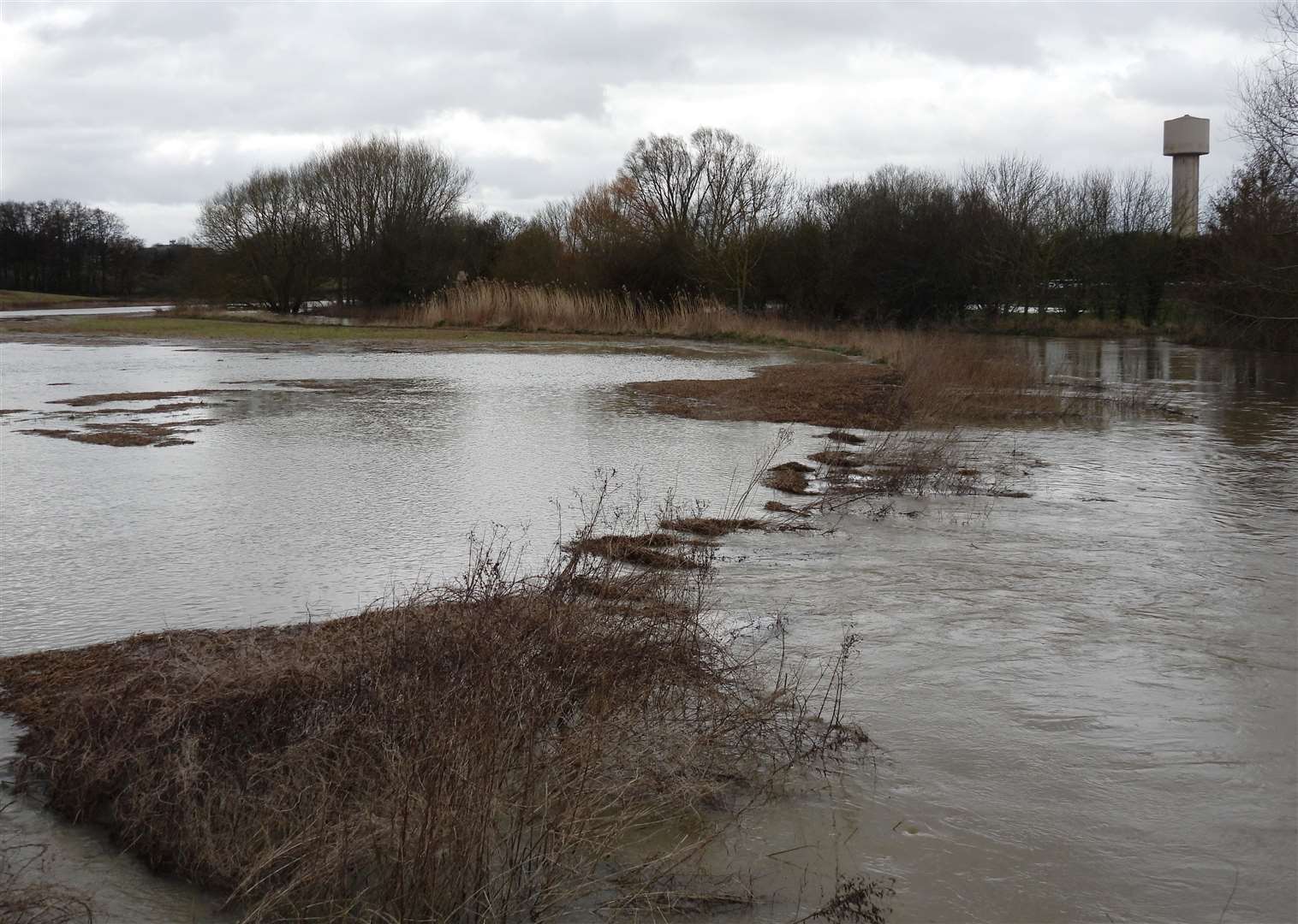 Flooding on the proposed plot earmarked for development off the A2070 is not uncommon. Picture: John Bailey