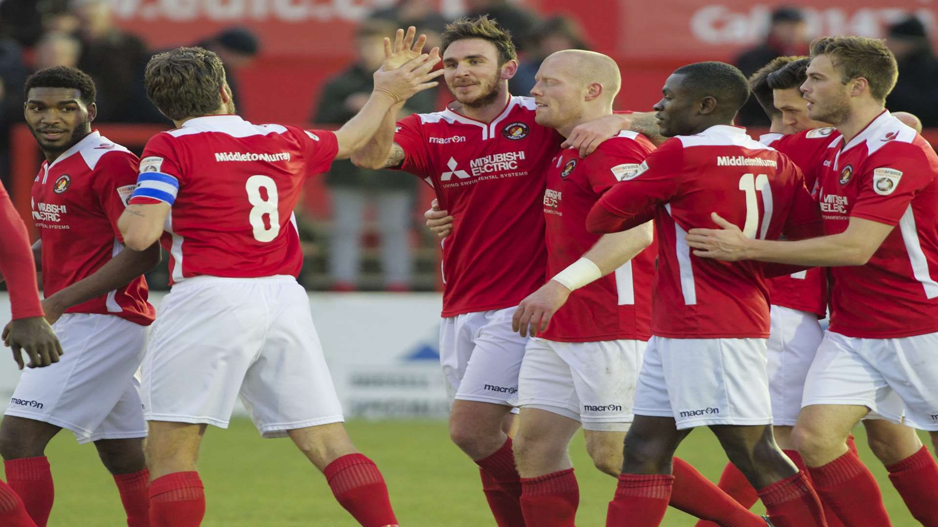 Matt Johnson (centre) takes the congratulations after making it 1-1 Picture: Andy Payton