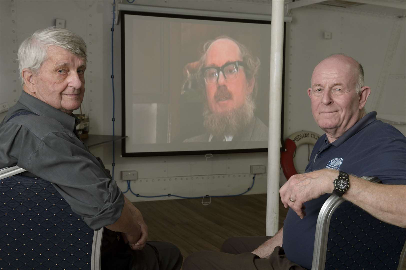 Publicity officer Brian Goodhew, left, and volunteer Mark Bathurst with a showing of old Medway Queen news footage. Regular open day for the Medway Queen paddle steamer, at Gillingham Pier, Gillingham. It's also the Dunkirk evacuation anniversary and as a veteran ship the Dunkirk pennant is being flown.Picture: Andy Payton (2333248)