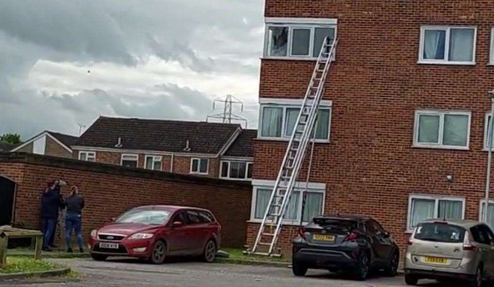 Fire crews are using a ladder to try to reach the man in Clockhouse, South Ashford. Picture: Liane Castle