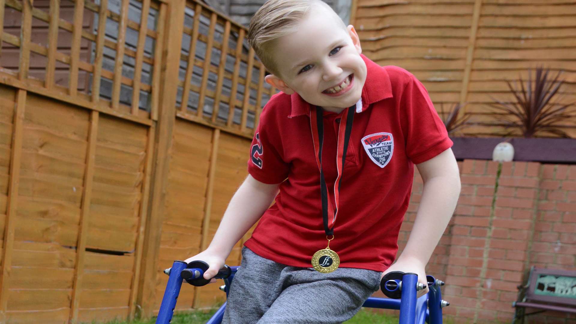 Harry Bailey at home with his medal