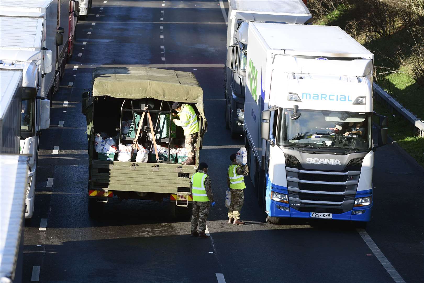 Army soldiers hand out food and water to the stranded drivers on the M20 between junction 10a and 11. Picture: Barry Goodwin