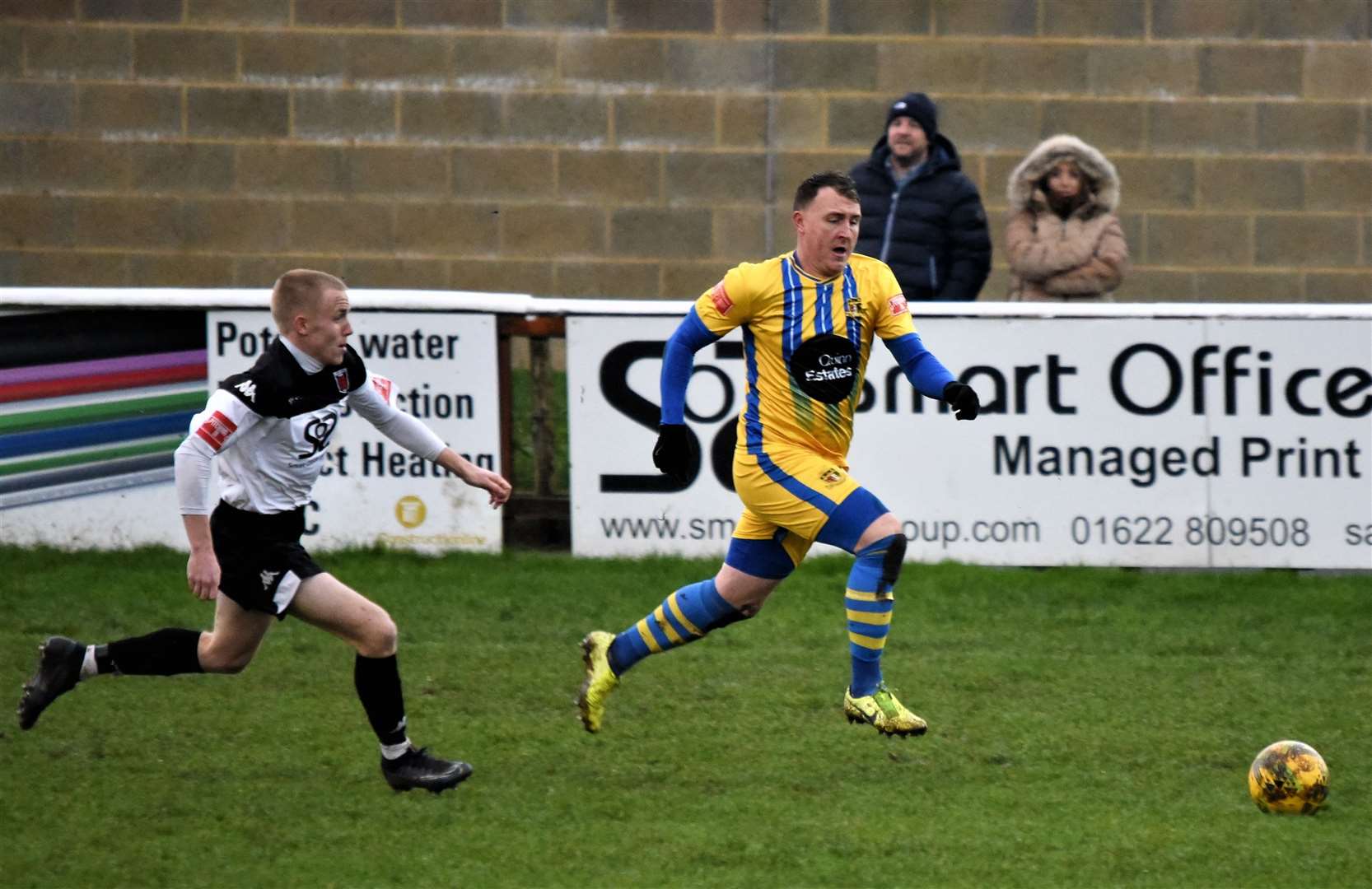 Benedict Bioletti chases down Sittingbourne man Alex Flisher in December at Salters Lane. Picture: Ken Medwyn