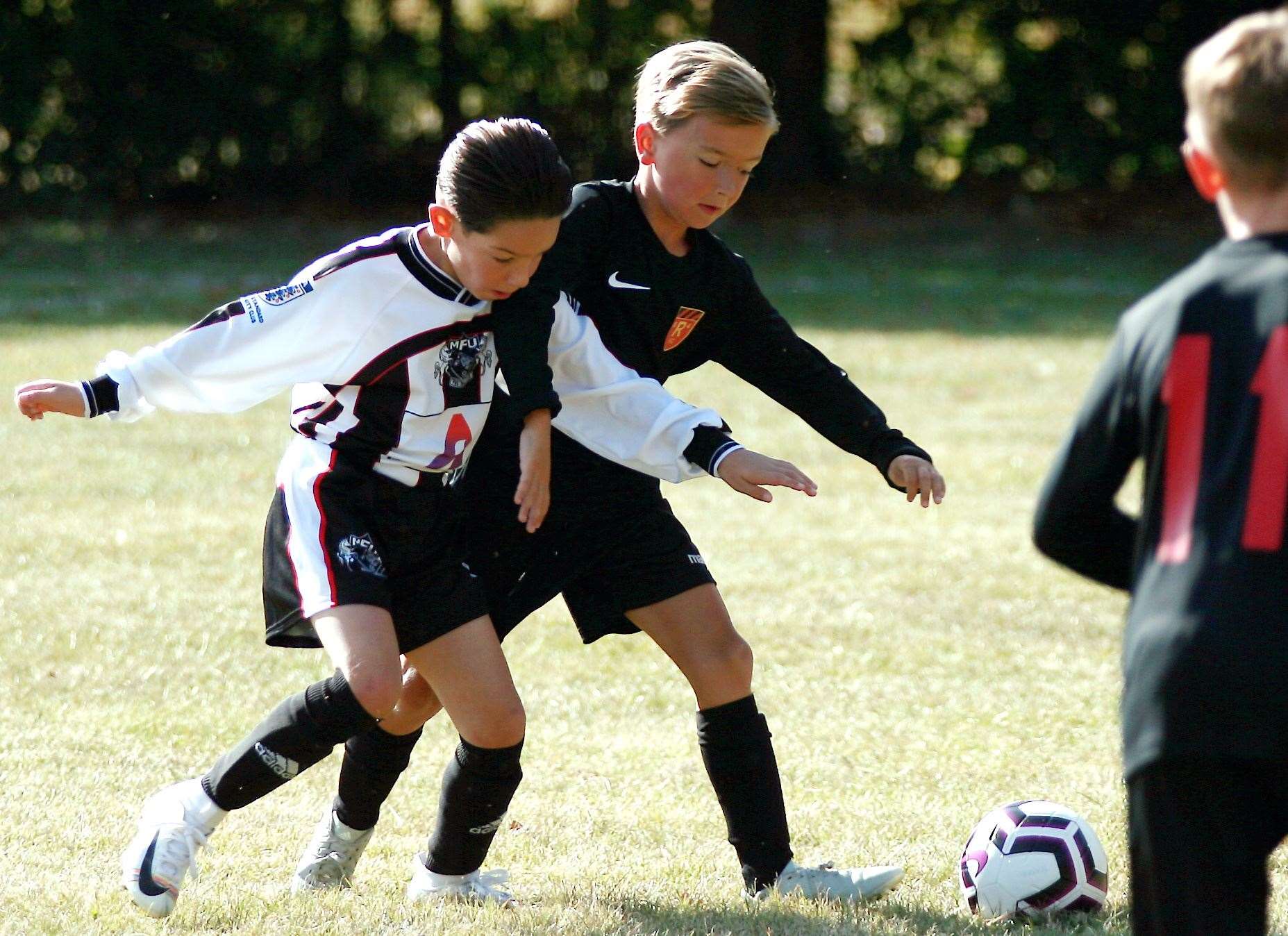 Rainham 84 Devils under-9s tangle with Milton & Fulston United Athletic under-9s Picture: Phil Lee