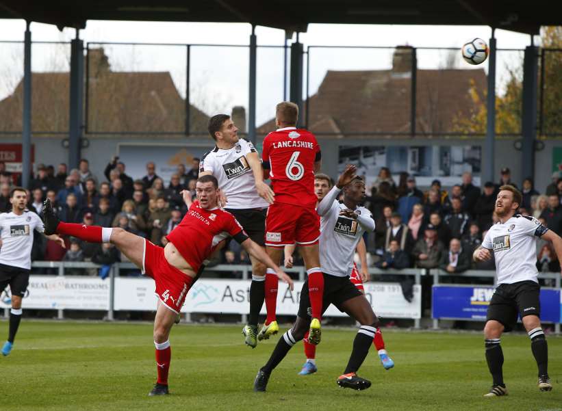 Tom Bonner jumps with Ollie Lancashire for a header Picture: Andy Jones