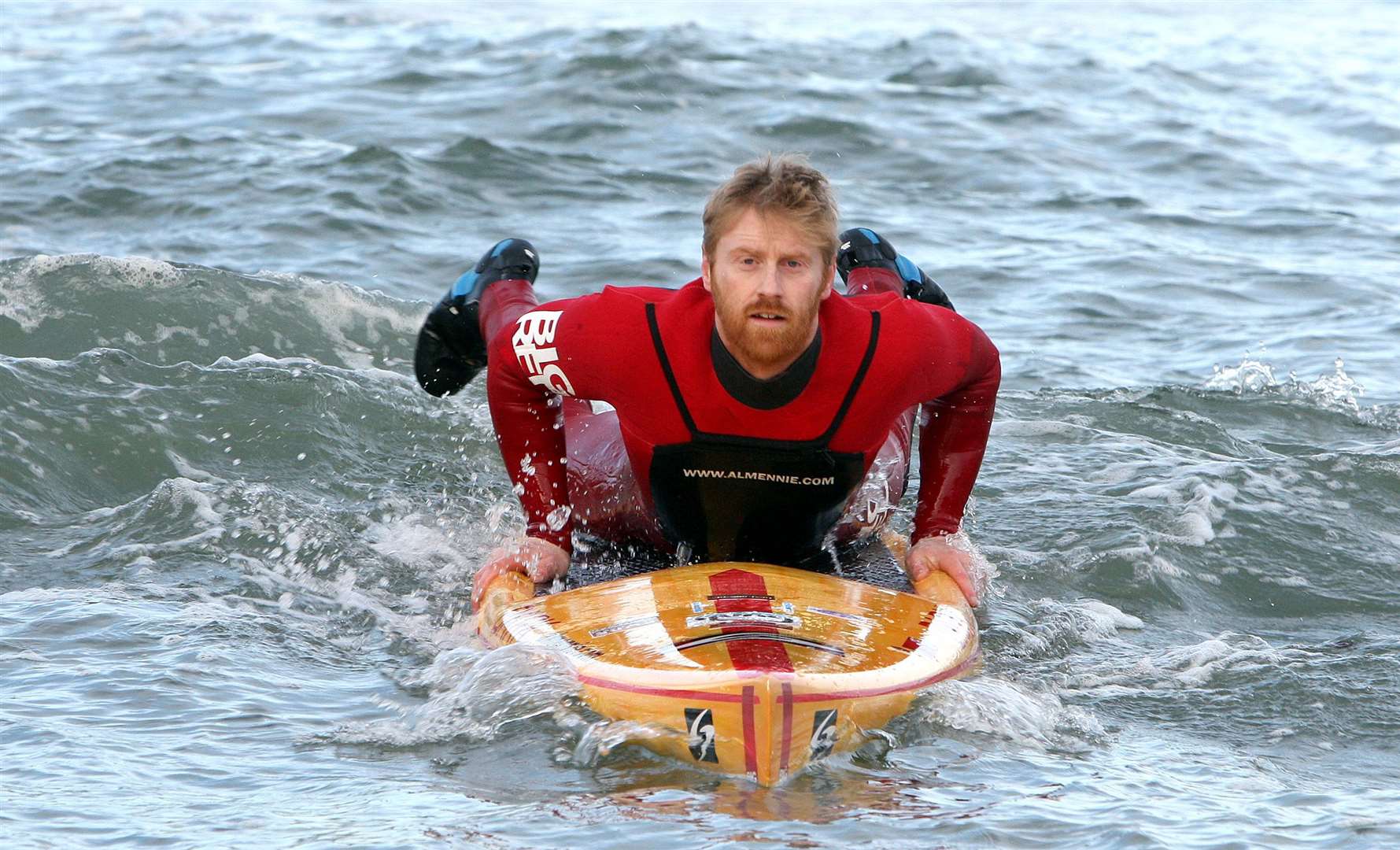 World-renowned surfer Al Mennie from Portrush, Northern Ireland with his paddle board on the north Antrim coast (Paul Faith/PA)