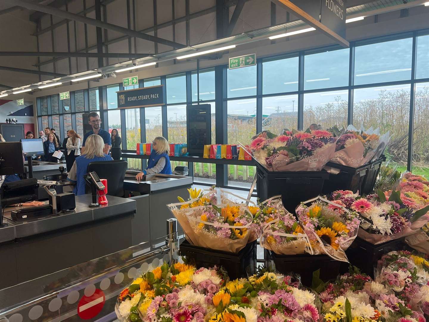 Customers entering the new Aldi and inside the store