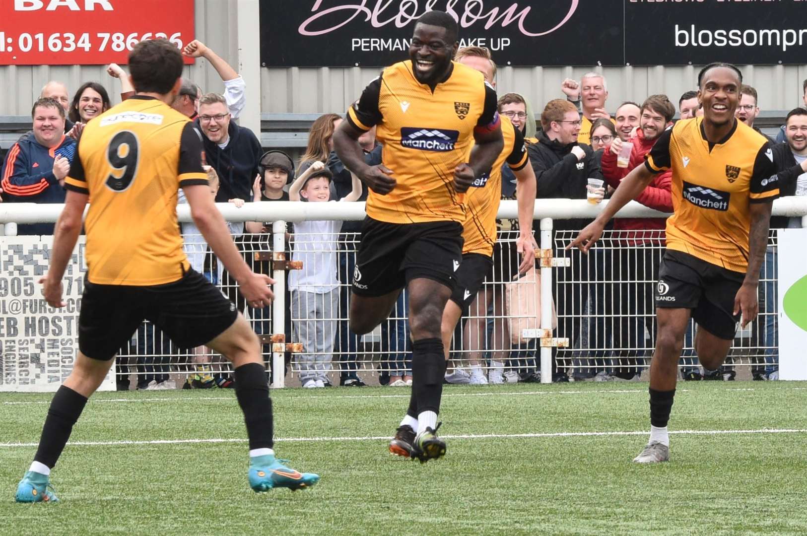 George Elokobi, centre, celebrates scoring in his final game before retirement Picture: Steve Terrell