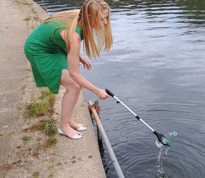 Hannah Temple taking a water sample from the River Medway