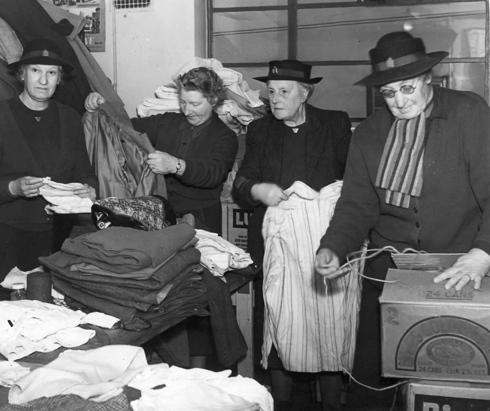 Relief workers sorting through clothes donated for the needy