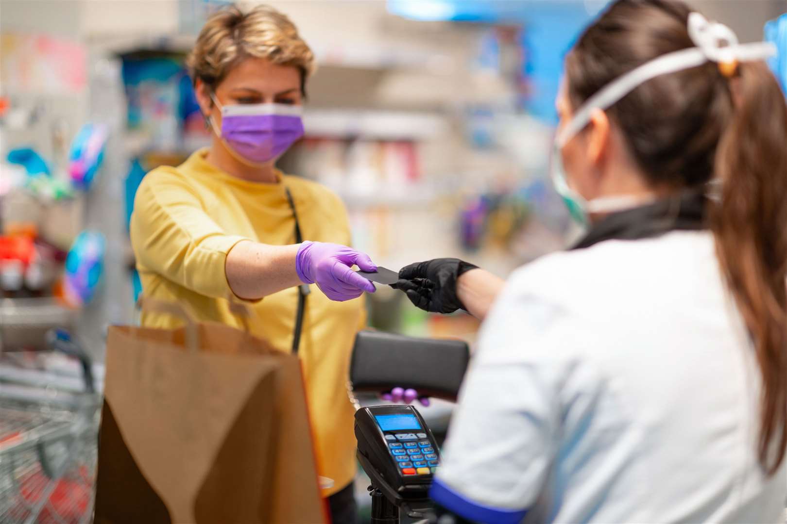 Face masks are compulsory in shops unless people are exempt from wearing them. Library picture