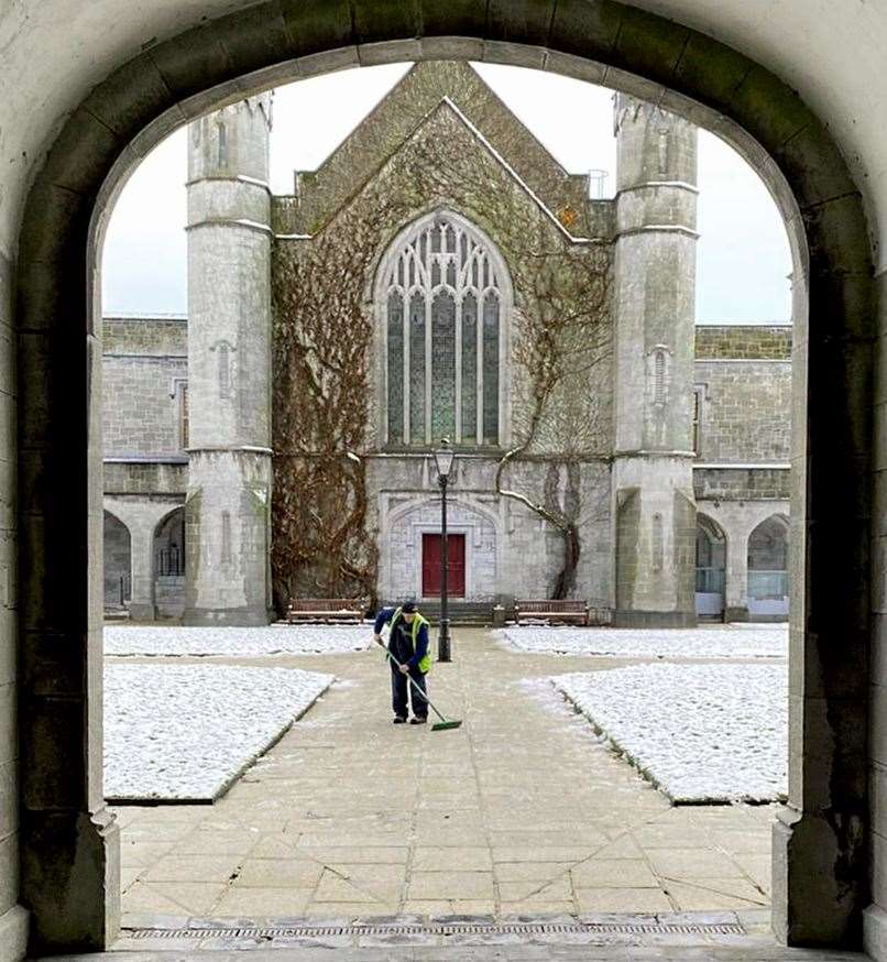 A staff member at the University of Galway clears snow from pathways ahead of a graduation ceremony on Thursday (Sheila Gorham/PA)