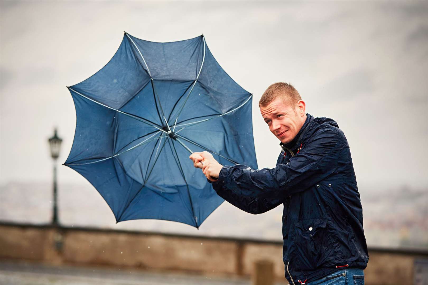 Umbrellas could be ruined later as strong winds hit Kent. Stock image