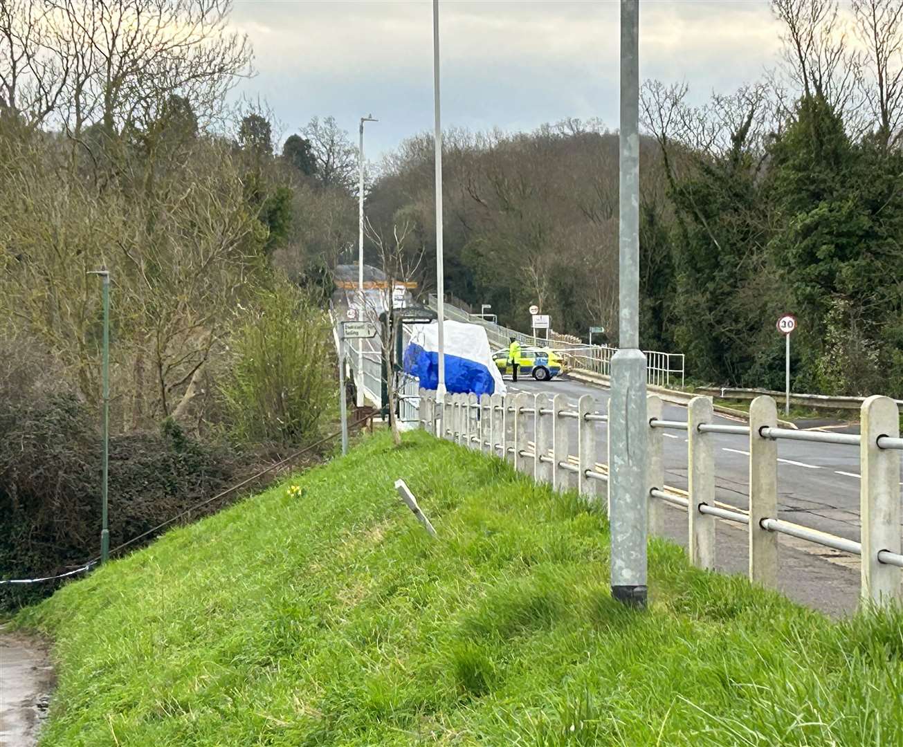 A white tent has been erected near a bus stop in the village