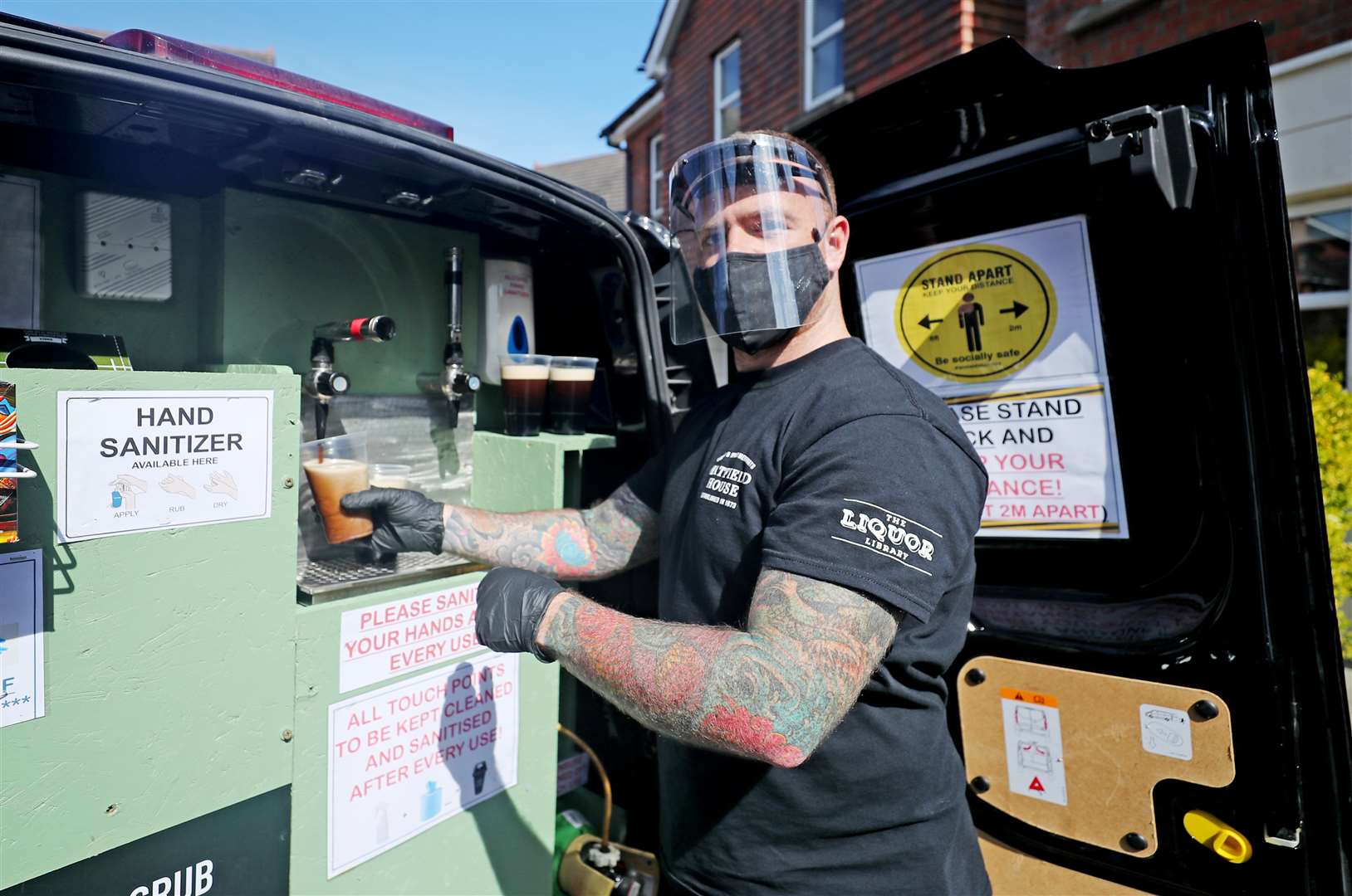 Harry McKeaveney pulls a pint in Belfast (Niall Carson/PA)