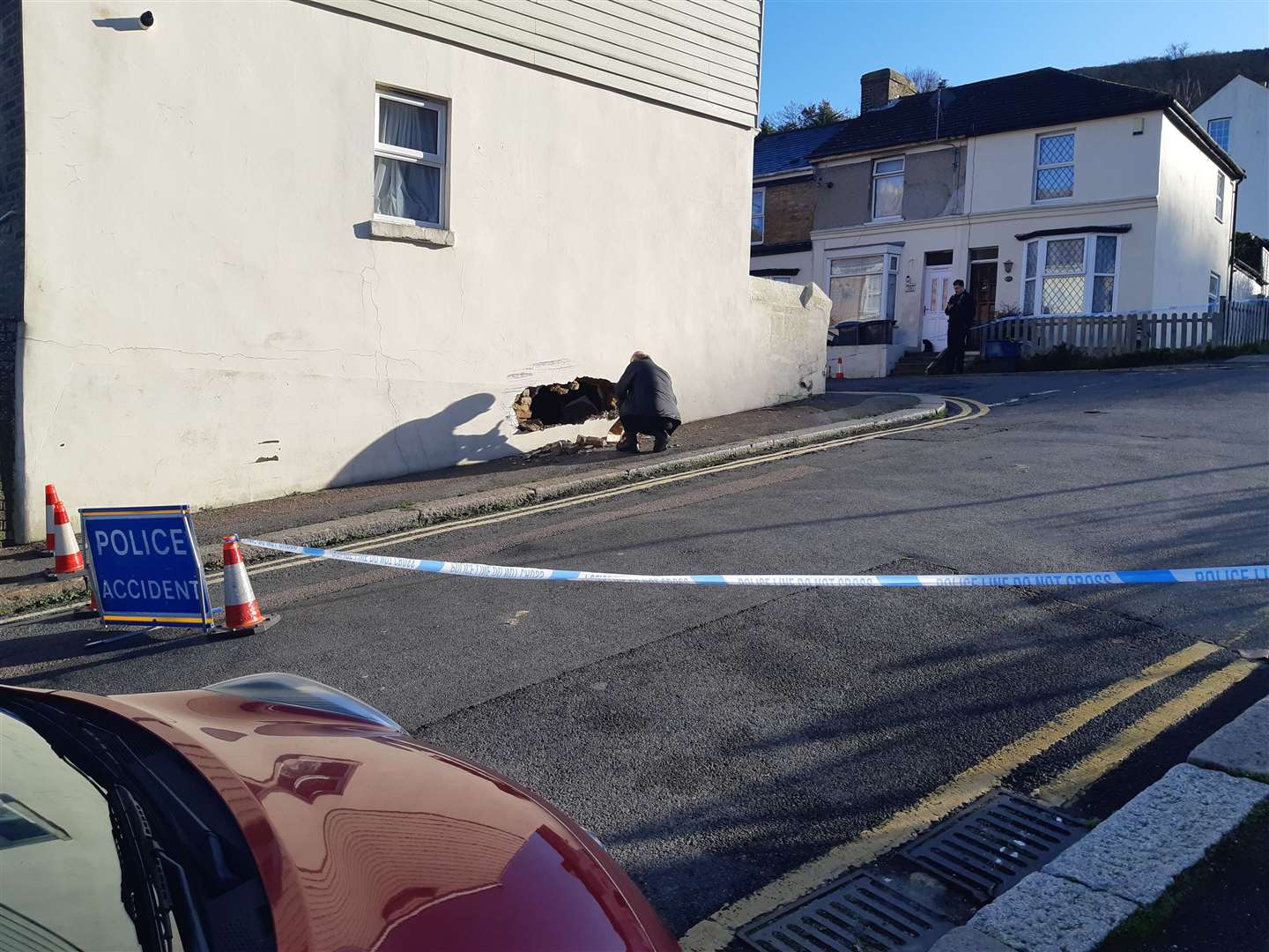 There is a hole in the wall where the car hit it