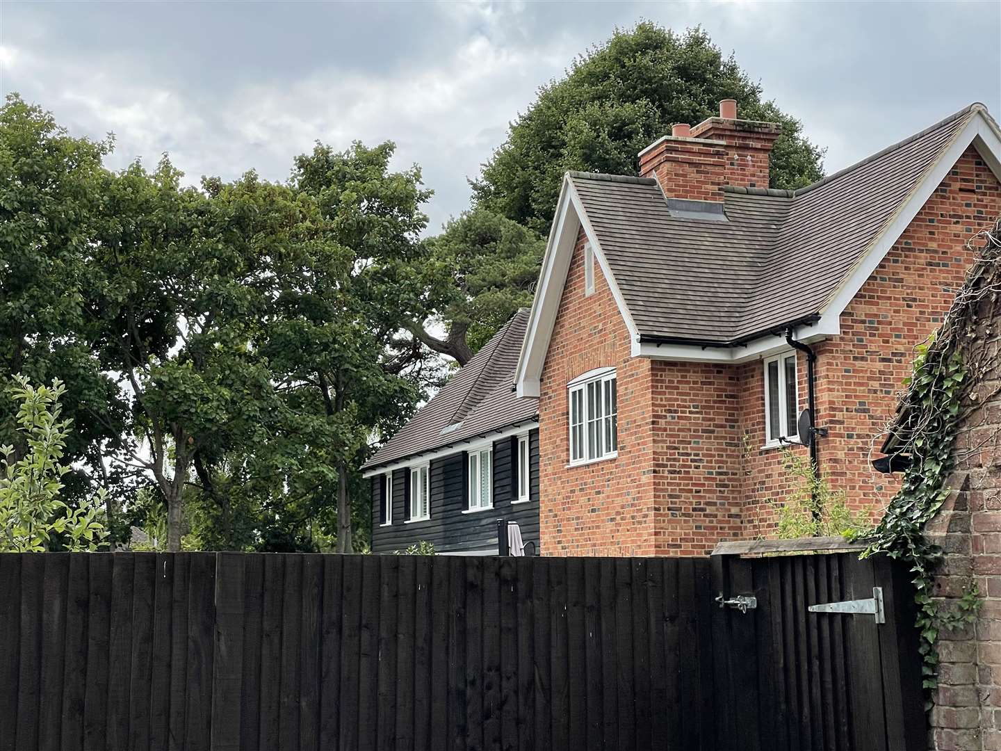 There are new-build houses next to the pub with similar black cladding