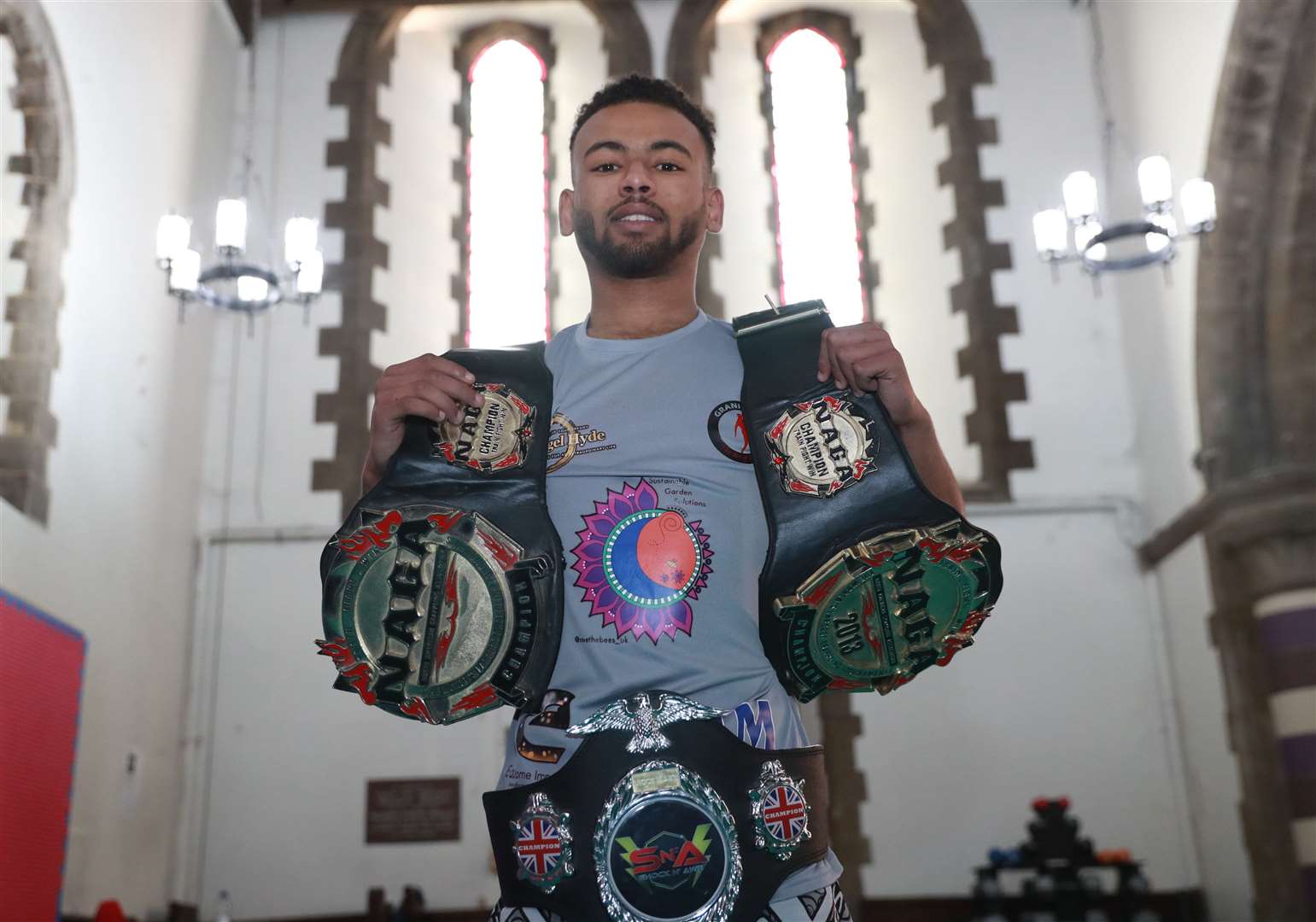 Kayne with three of his belts