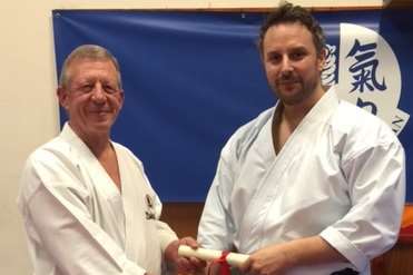 Sensei Dave Hazard (left) presents Paul Herbert with his 6th Dan