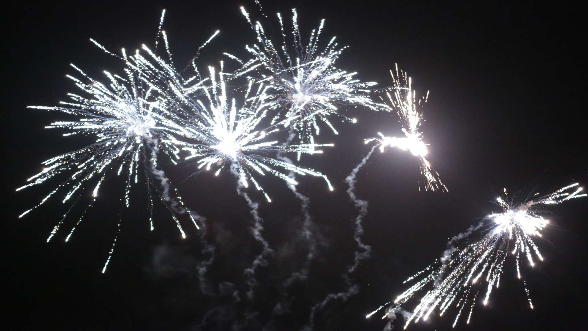 Youths set off fireworks on a busy road. Stock image.