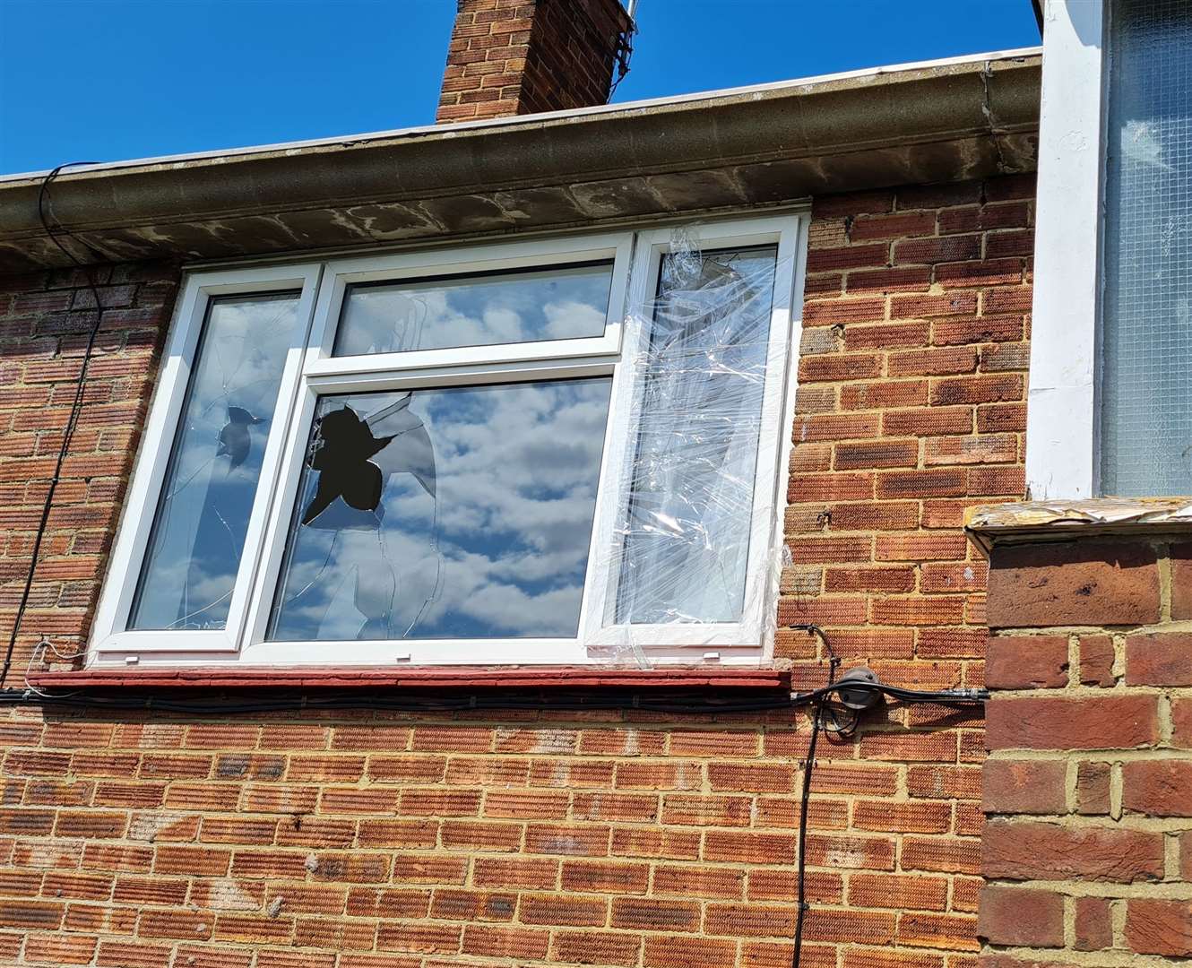 Smashed windows can be seen from outside the property