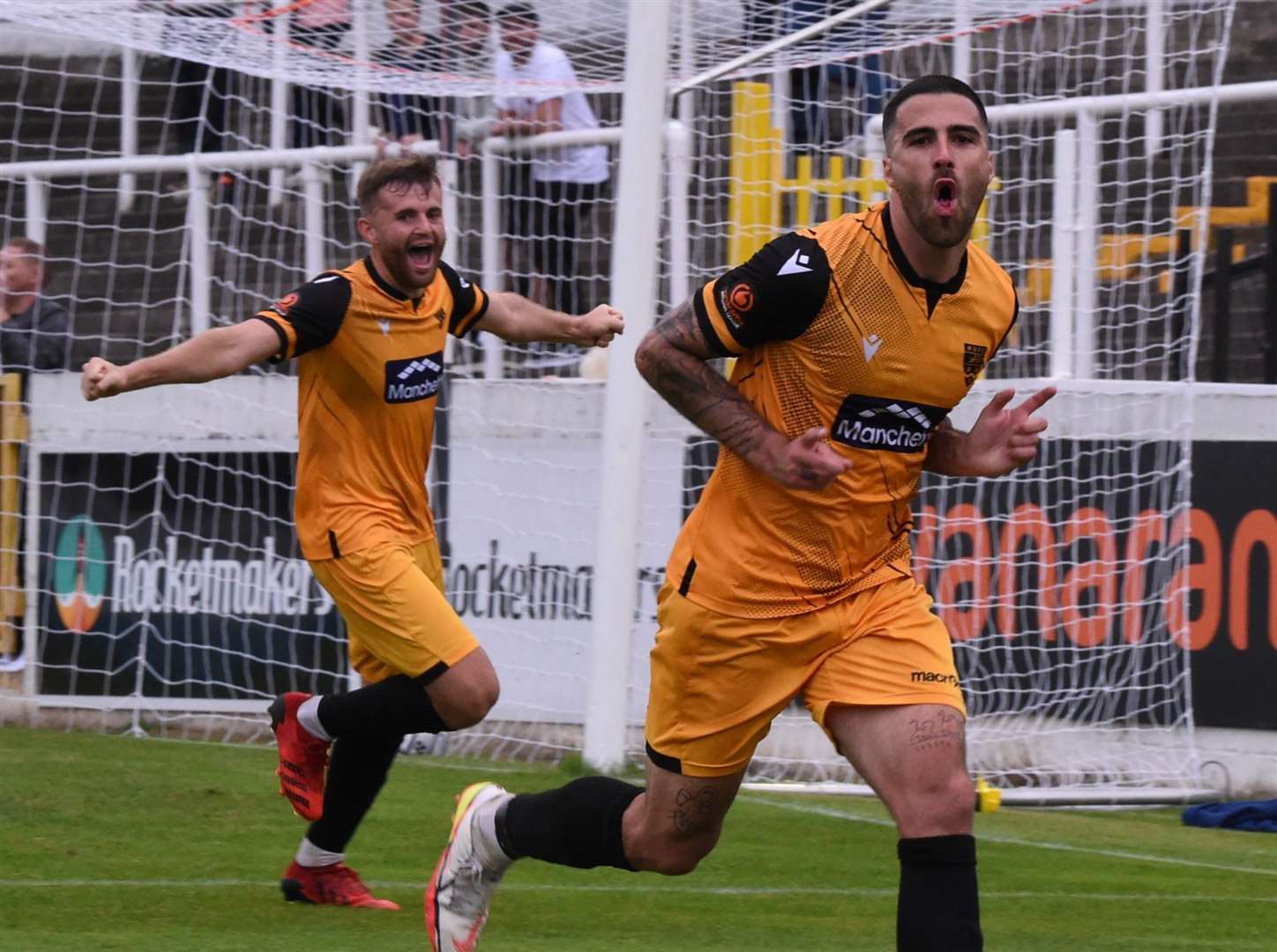 Joan Luque celebrates his second goal in Maidstone's win at Bath, tracked by housemate Regan Booty Picture: Steve Terrell