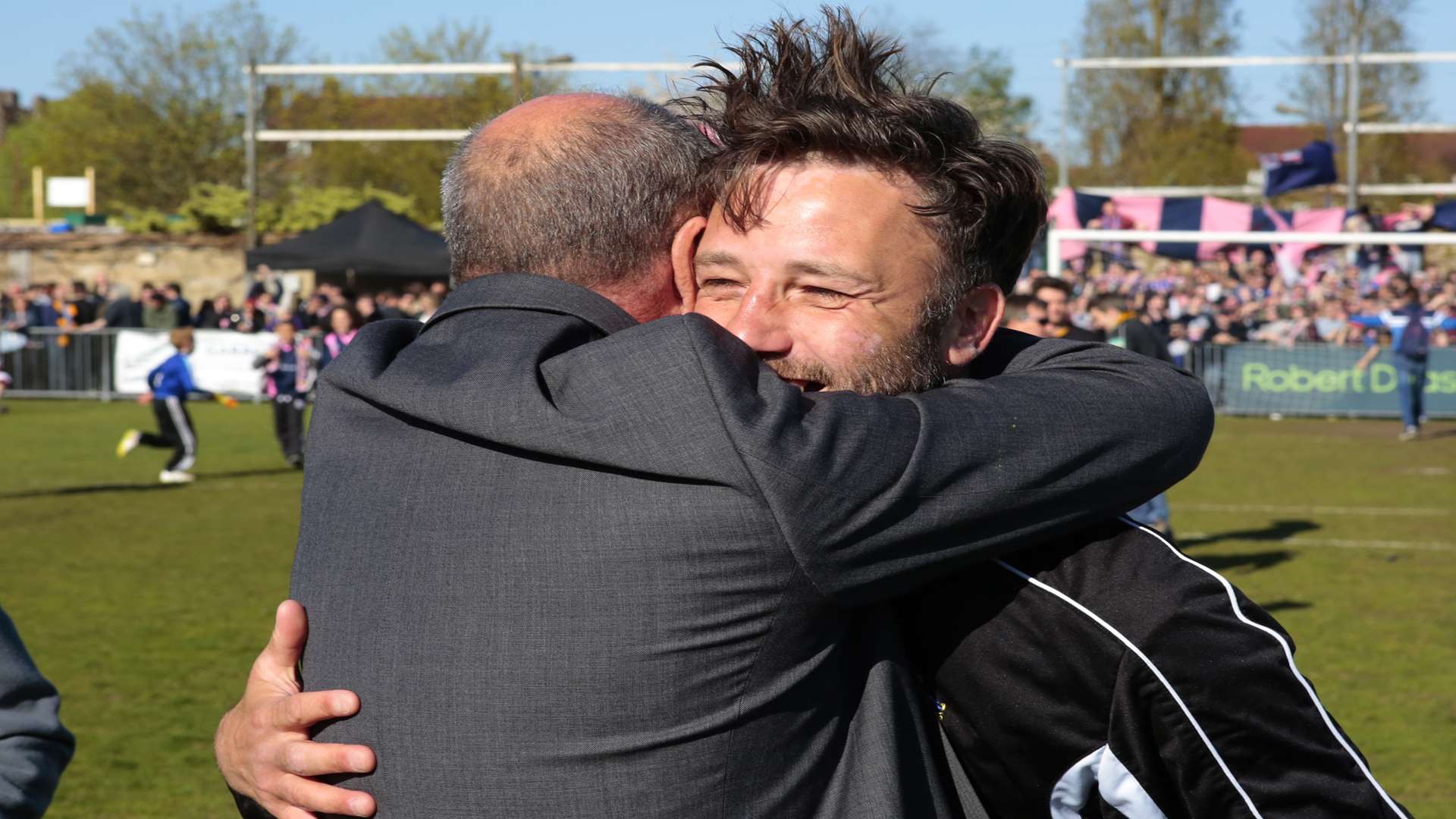 Boss Jay Saunders embraced by former Maidstone goalkeeper Les Apps at Dulwich Picture: Martin Apps