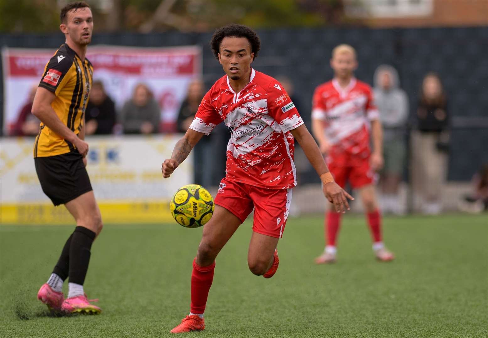 Midfielder TJ Jadama turns away from Folkestone forward Dan Smith for Ramsgate. Picture: Stuart Watson