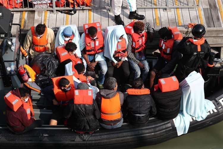 A group of people waiting on a Border Force rib (Gareth Fuller/PA)