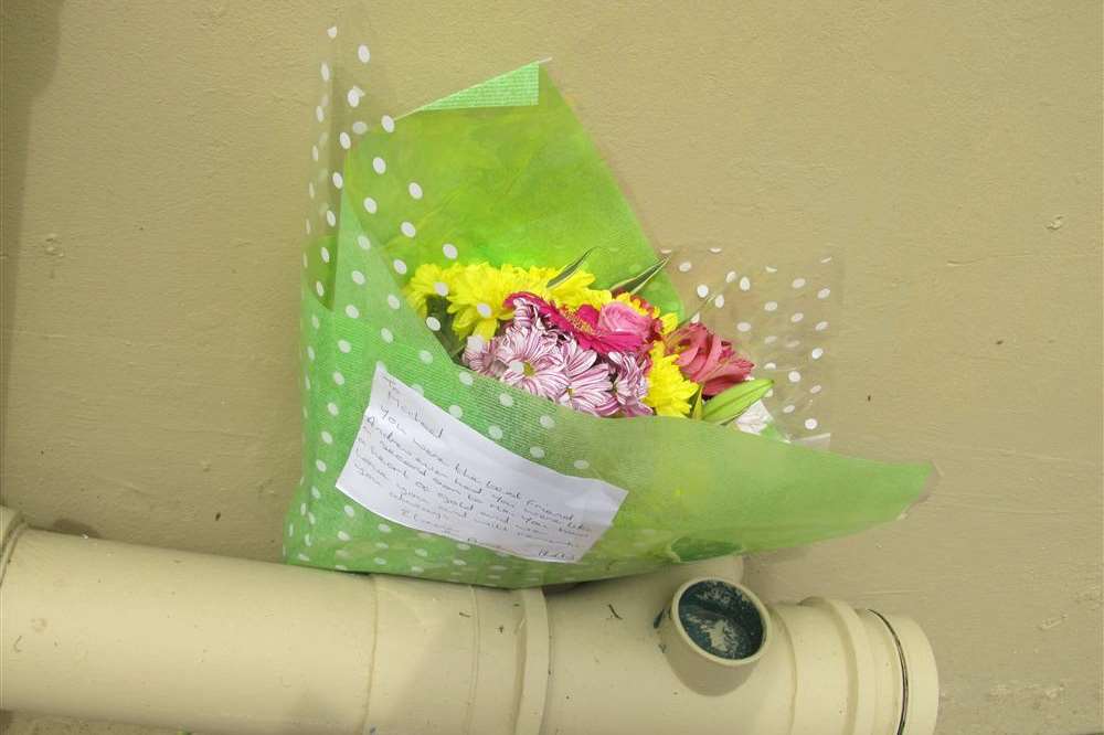 Flowers left at the site with a touching message