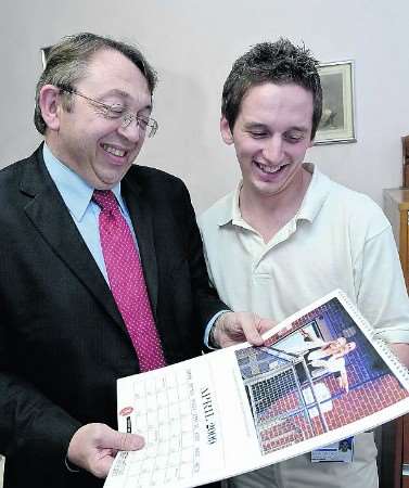 Michael Carlton shows Paul Clark his image in the calendar which recreates a scene from Titanic in which he poses as Leanardo DiCaprio