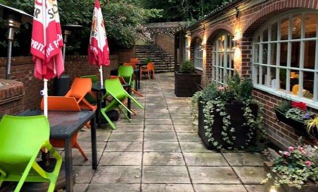 The patio area, with brightly coloured chairs, at the Amherst Inn in Sevenoaks