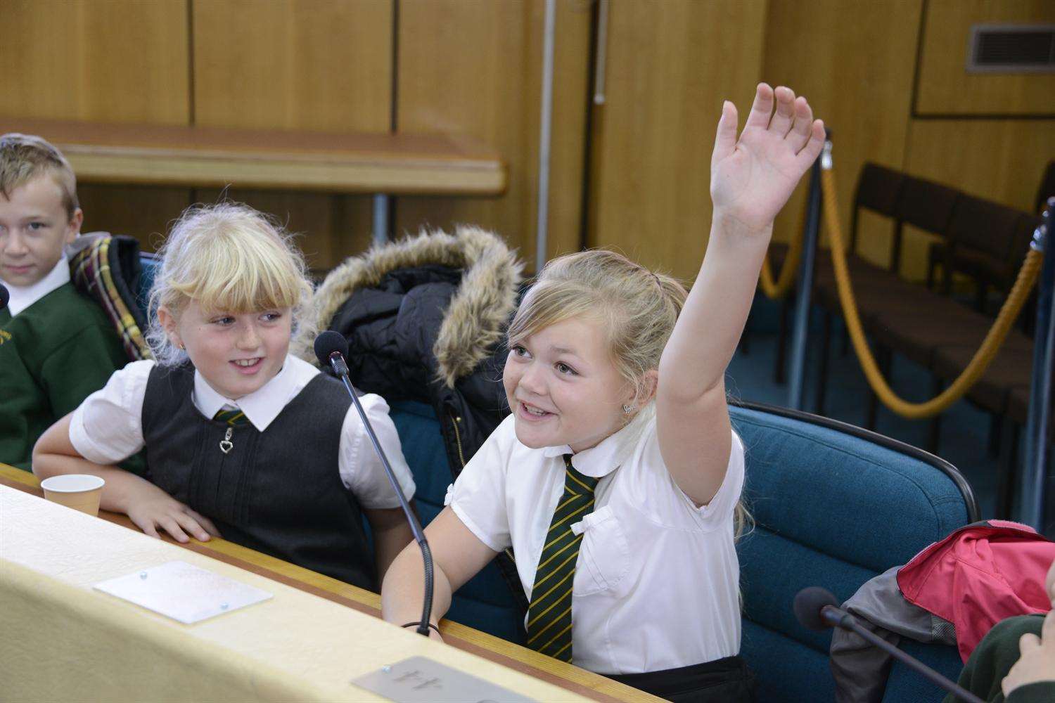 Ashford Council Chamber launch of KM Green Champions. Alana Smith from St Simon's school asks a question watched by school mate Kayla Sackett.