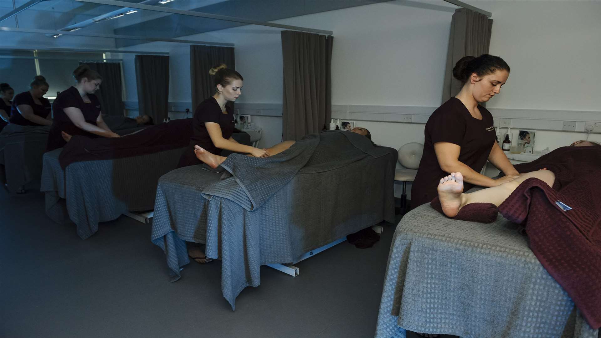 The spa area with students giving massages. Official opening of the Miskin Spa, salon and make-up studio