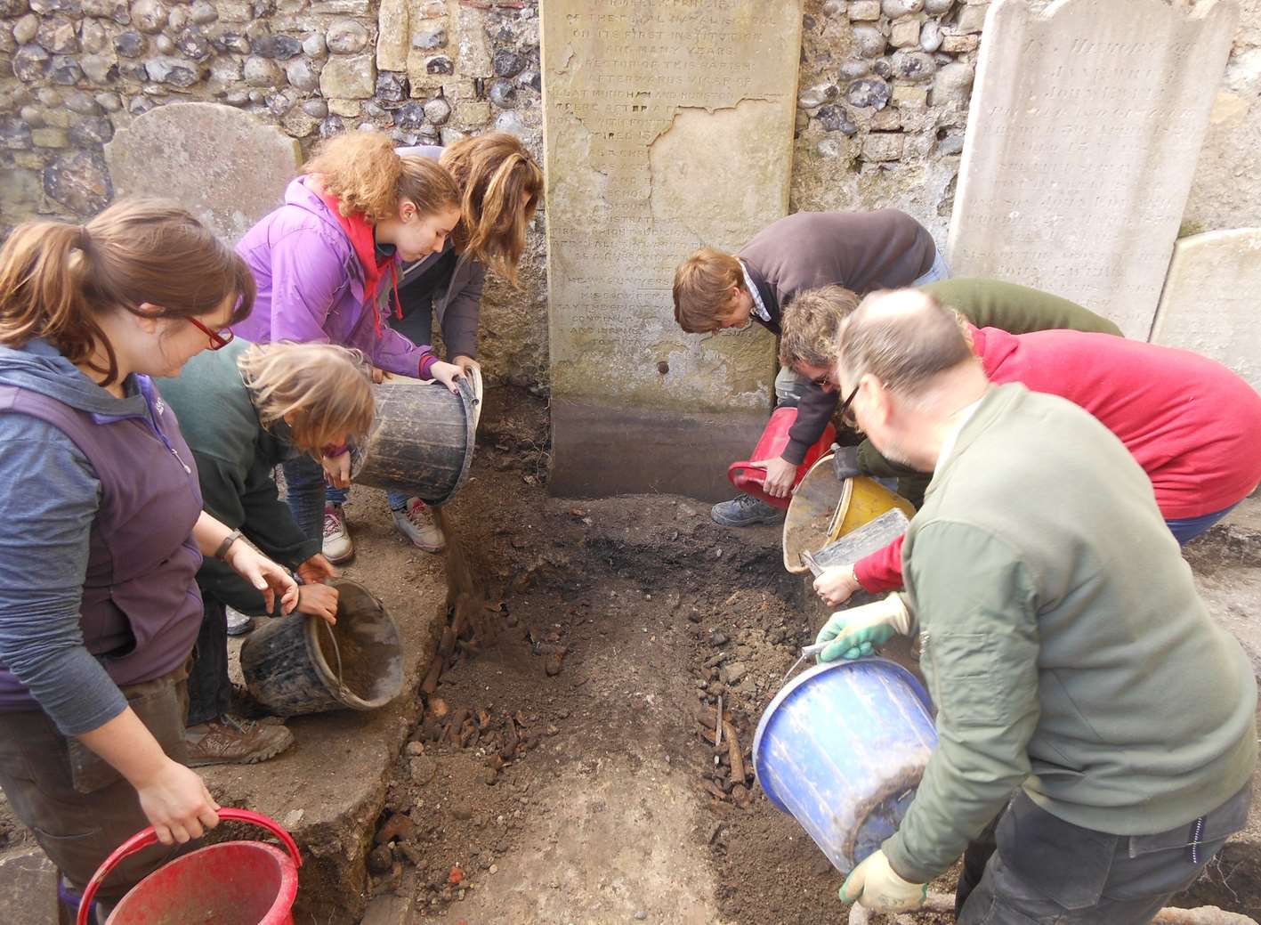 After a respectful moment of silence from volunteers the collected bones were covered with soil.