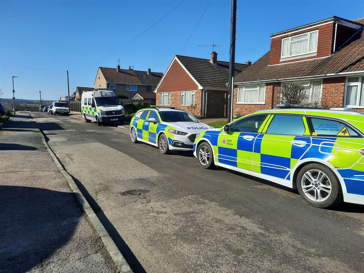 A van and two police cars remain outside the property in Laburnum Lane, Sturry, following the raid