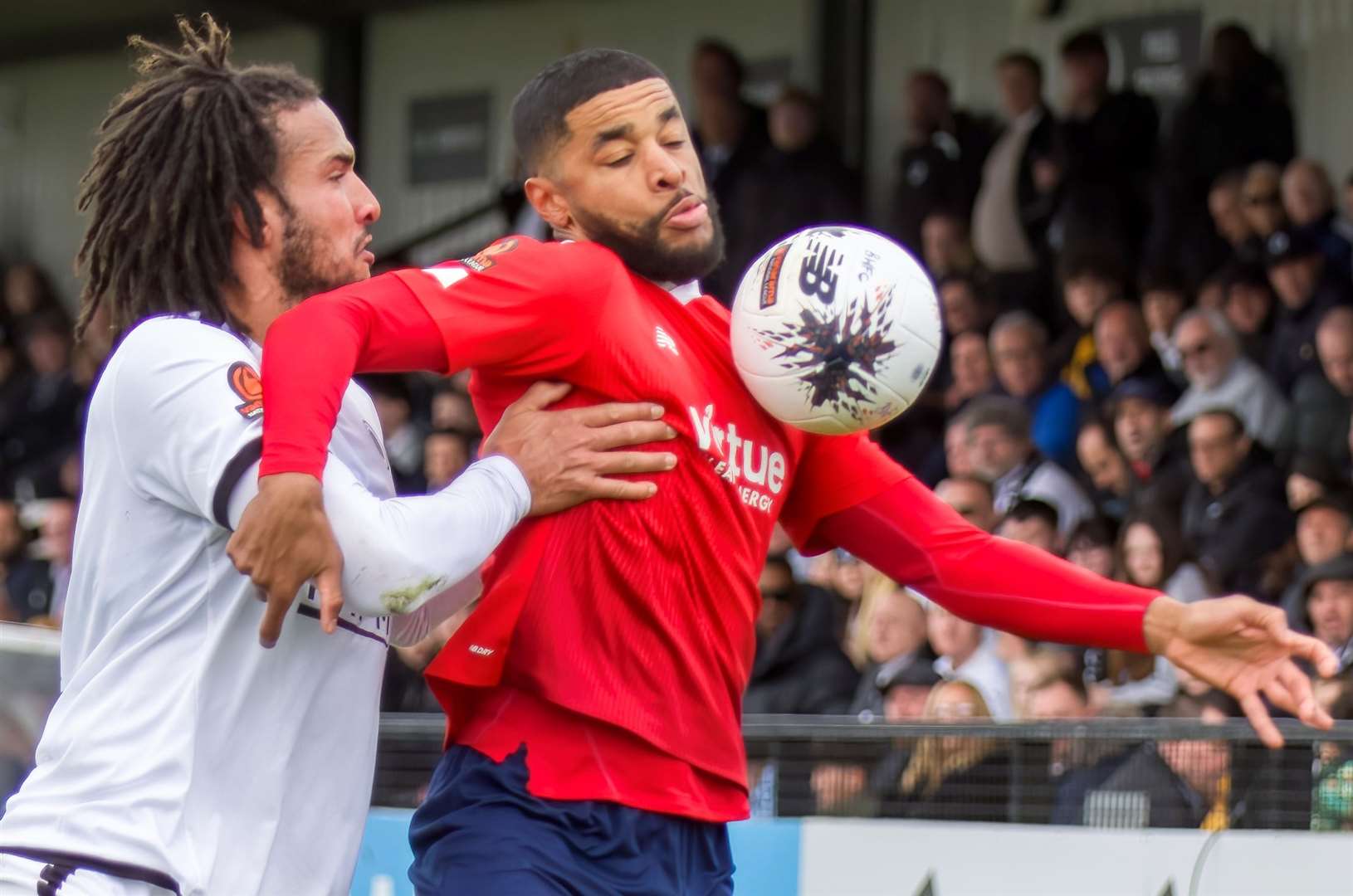 Ebbsfleet forward Dominic Samuel holds up ex-Fleet defender Chris Bush. Picture: Ed Miller/EUFC