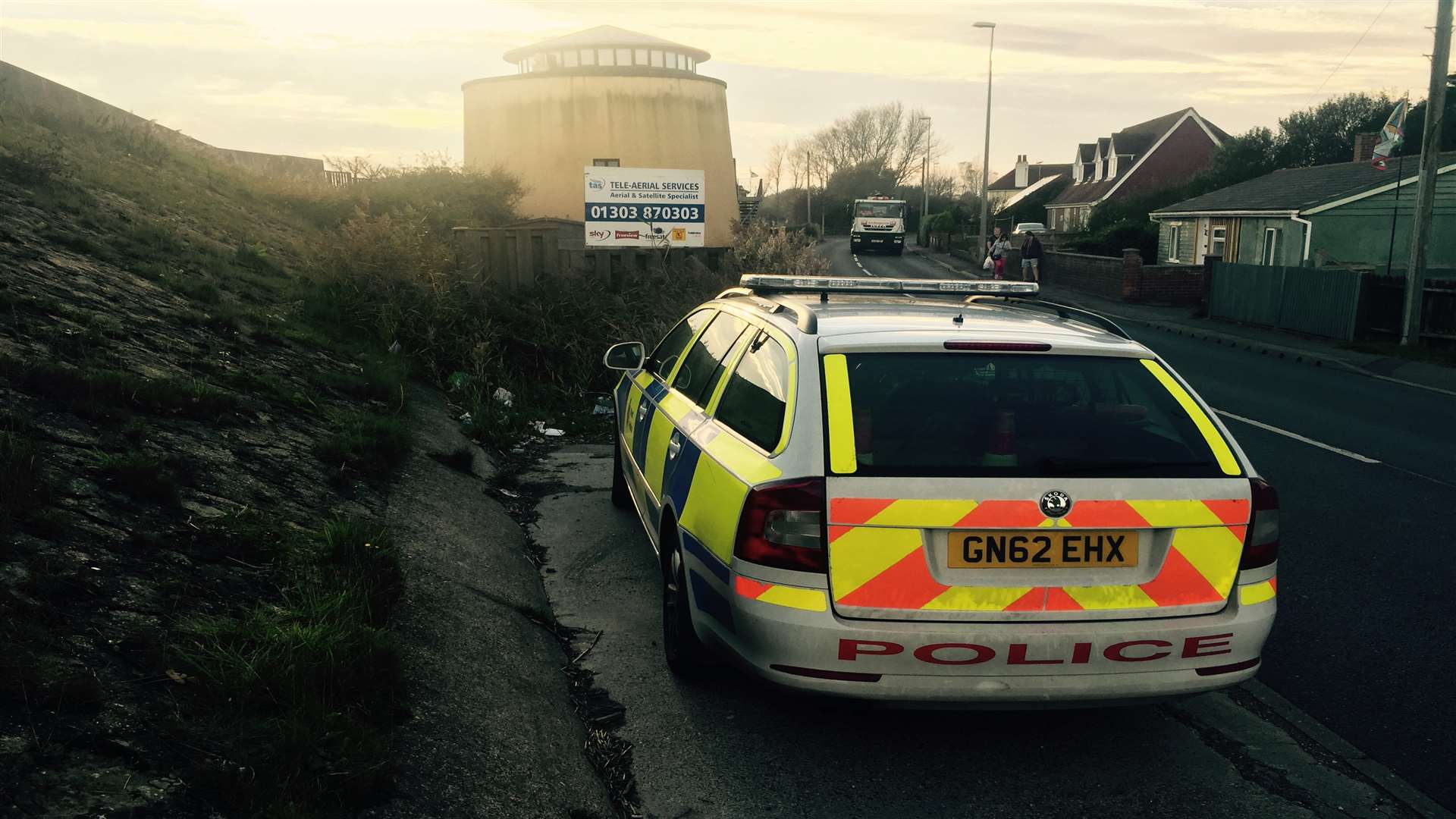 A police car parked near the scene of the incident