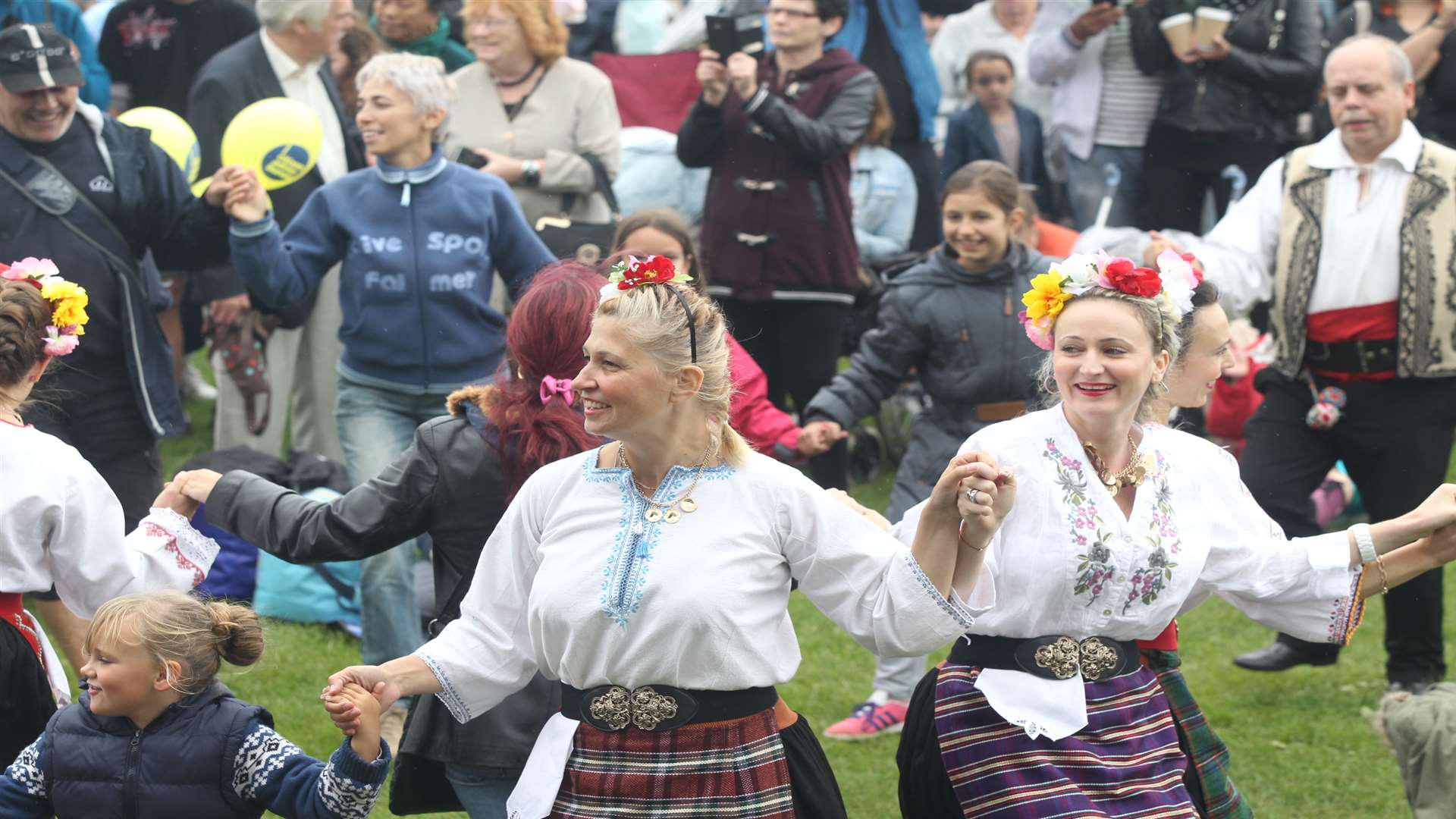 Kitka, a Bulgarian Dance Group perform amongst the public at Maidstone Mela at Mote Park in Maidstone. Picture: John Westhrop.