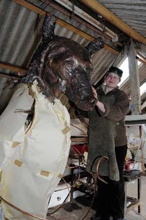 Emily Stone working on her big bear sculpture