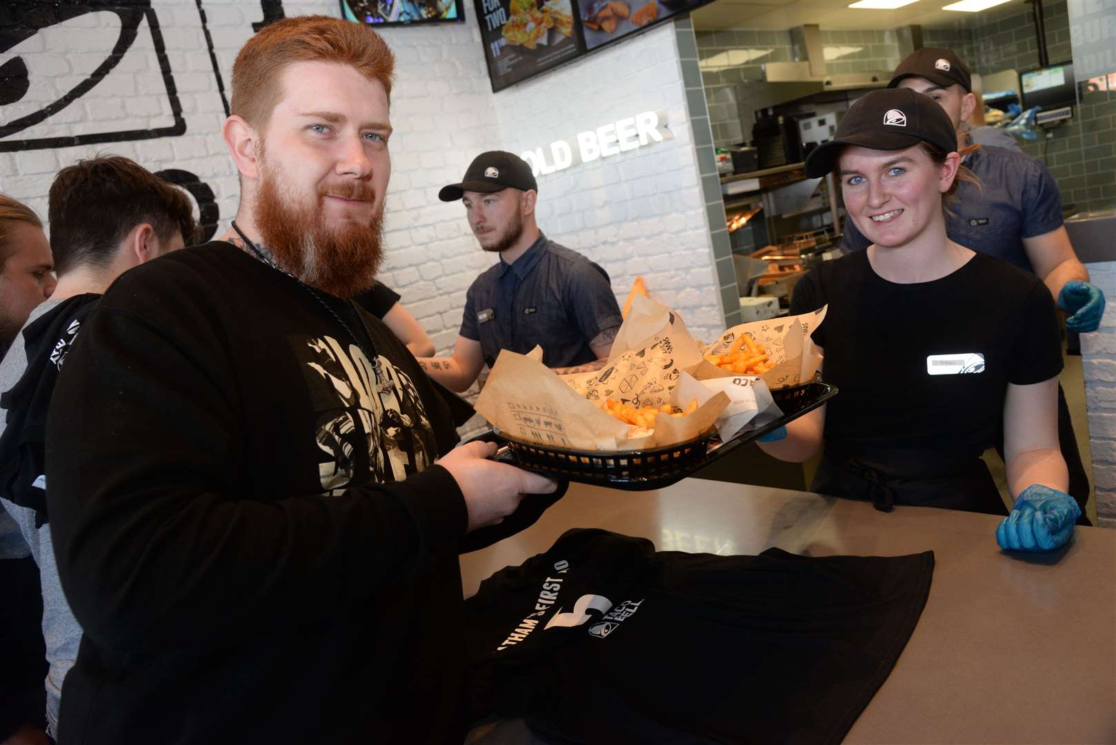 James Roche collects his order from Bethany Griffin after the opening of the Taco Bell at The Quays, Dock Head Road, St Mary's Island, Chatham on Wednesday. Picture: Chris Davey..... (10357679)