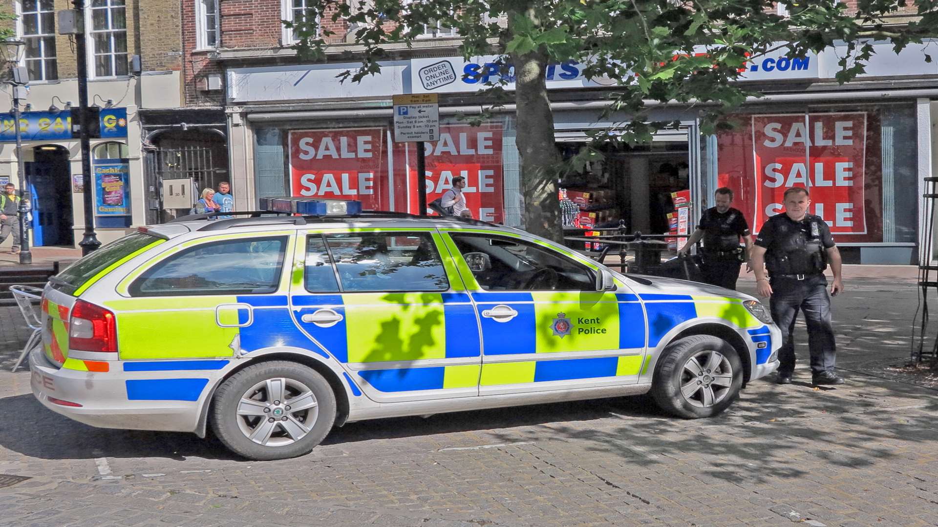 Police remove the bag from the scene. Photo by Andy Clark