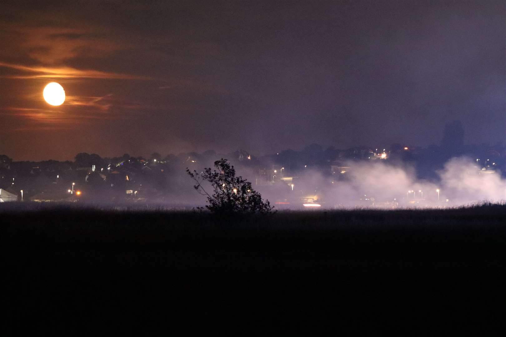 Firefighters tackle burning grass following a model aeroplane display at Barton's Point Coastal Park, Sheerness. Picture: John Nurden